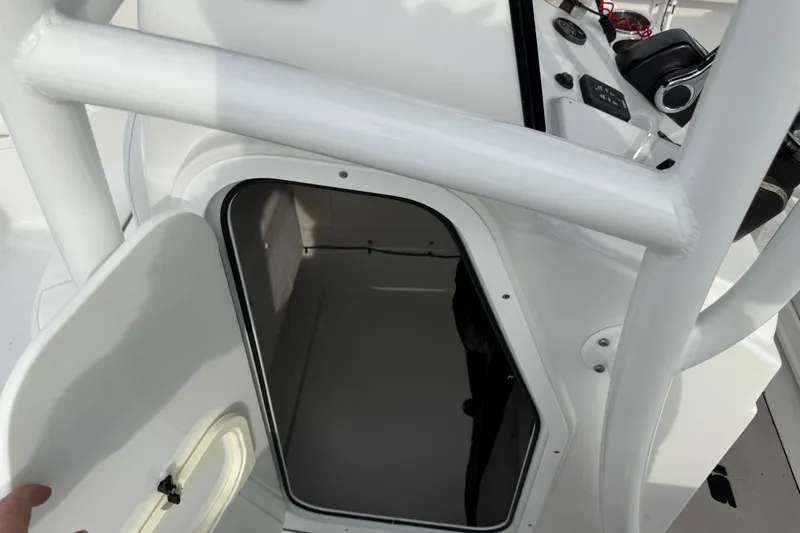 Slide: The Image of 2015 Sportsman Heritage 231 Center Console boat interior storage compartment. - 11