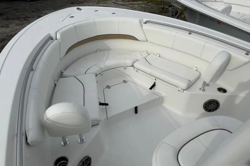 Slide: The Image of 2015 Sportsman Heritage 231 Center Console boat with white cushioned seating area. - 12