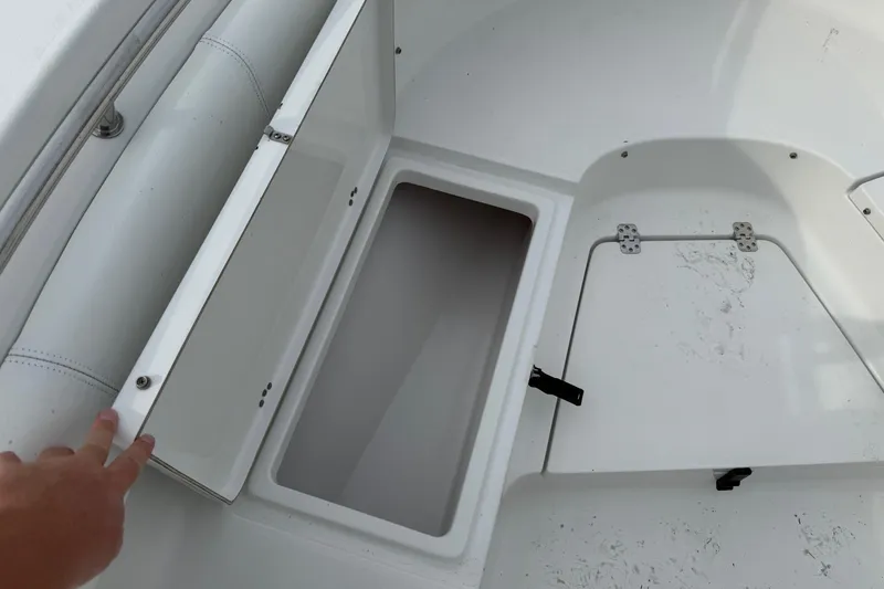 Slide: The Image of 2015 Sportsman Heritage 231 Center Console boat storage compartment open. - 14