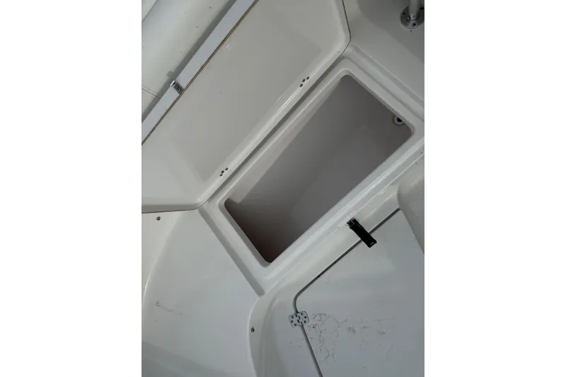 Slide: The Image of Open storage compartment on a 2015 Sportsman Heritage 231 Center Console boat. - 15