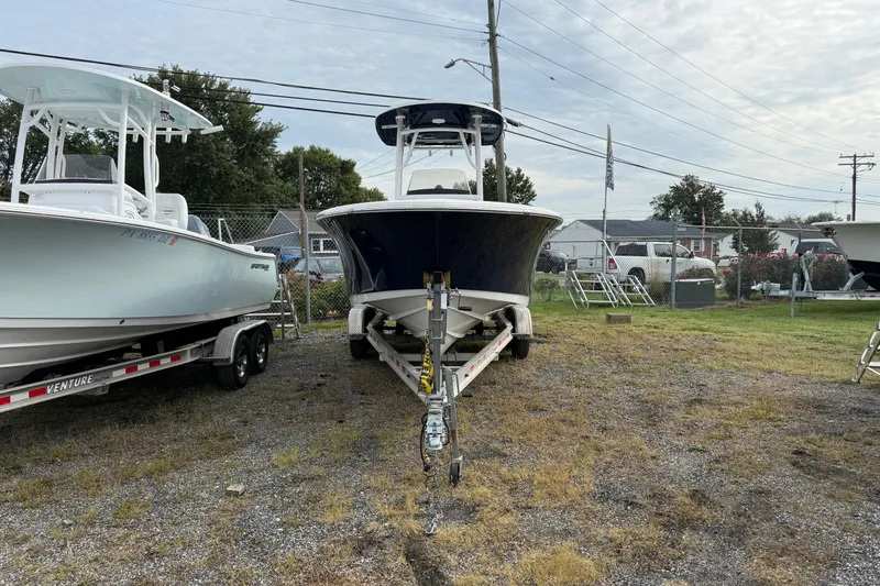 Slide: The Image of 2015 Sportsman Heritage 231 Center Console boat on trailer, parked outdoors. - 3