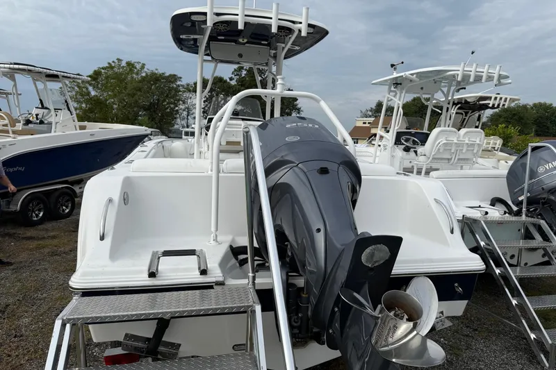 Slide: The Image of 2015 Sportsman Heritage 231 Center Console boat with Yamaha outboard motor, docked outdoors. - 5