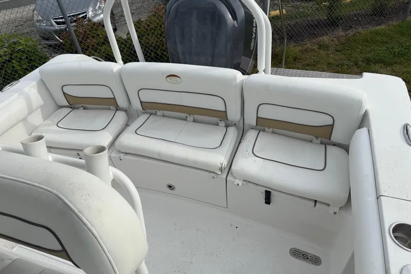 Slide: The Image of 2015 Sportsman Heritage 231 Center Console boat with white cushioned seating. - 7