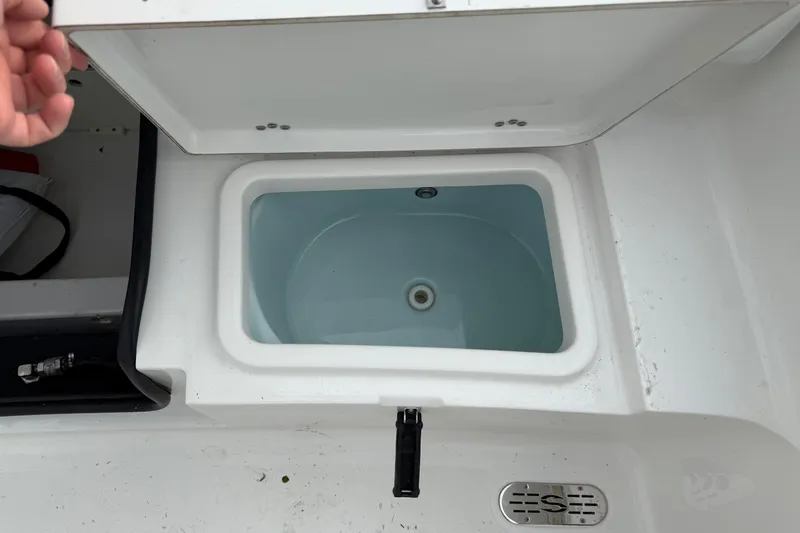 Slide: The Image of Open storage compartment on 2015 Sportsman Heritage 231 Center Console boat. - 9