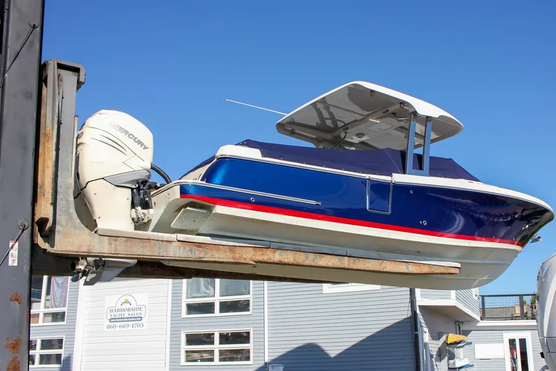 The Image of 2018 Chris-Craft Calypso 30 boat in showroom, blue and white design, Hampton Beach, NY. - 0