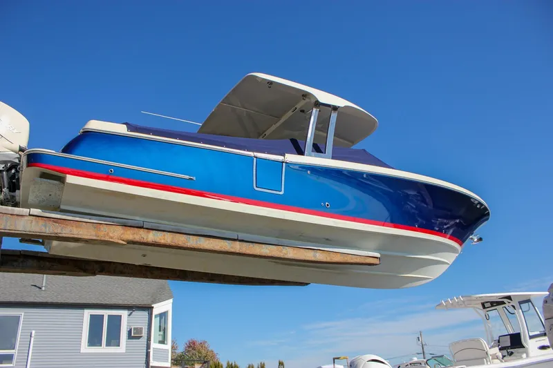 Slide: The Image of 2018 Chris-Craft Calypso 30 boat interior with cream seating and wooden flooring. - 11