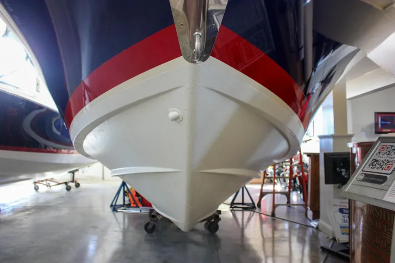 Slide: The Image of 2018 Chris-Craft Calypso 30 boat with blue hull and stainless steel details. - 17