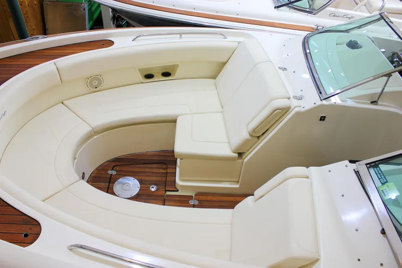 Slide: The Image of 2018 Chris-Craft Calypso 30 interior with teak flooring and elegant seating. - 18