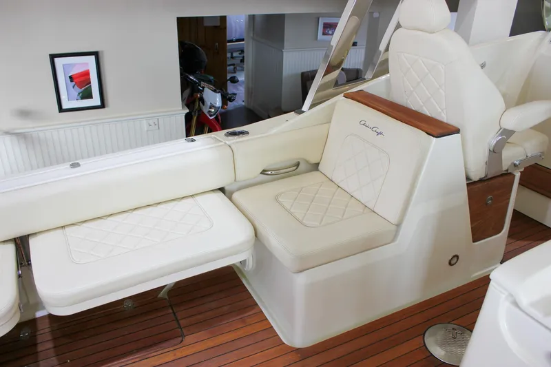 Slide: The Image of Luxurious interior of 2018 Chris-Craft Calypso 30 with elegant cream seating and wood accents. - 30