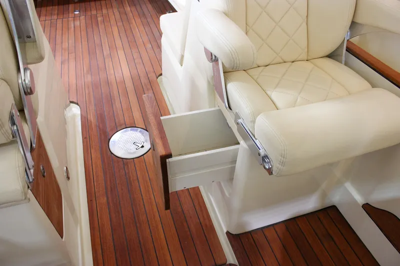 Slide: The Image of 2018 Chris-Craft Calypso 30 interior with teak flooring and cream leather seating. - 34