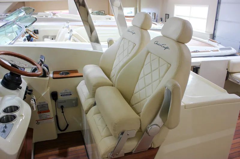 Slide: The Image of 2018 Chris-Craft Calypso 30 boat interior with luxurious cream leather seats and wooden steering wheel. - 35