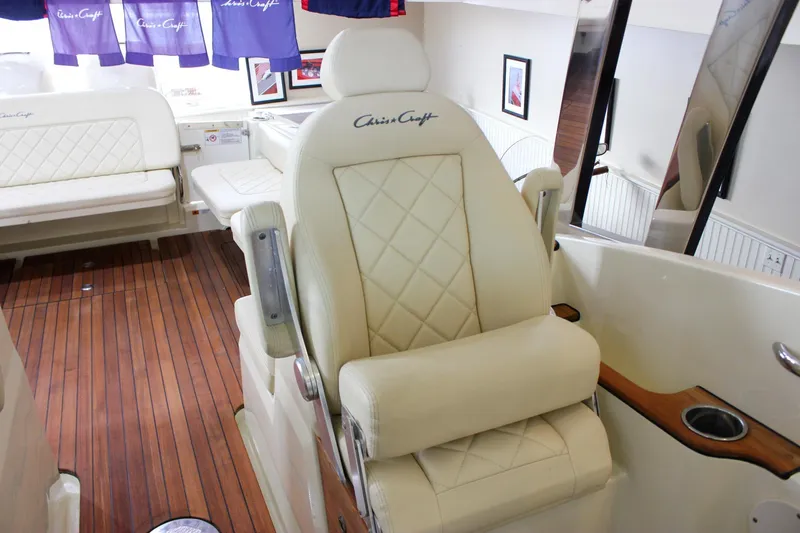 Slide: The Image of Luxurious interior of 2018 Chris-Craft Calypso 30 with plush seating and wood flooring. - 36