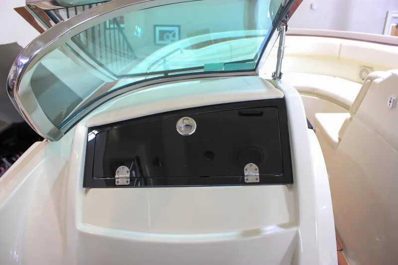 Slide: The Image of 2018 Chris-Craft Calypso 30 boat interior with windshield and storage compartment. - 38