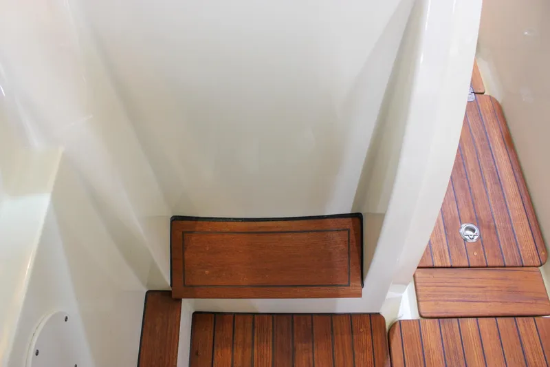 Slide: The Image of 2018 Chris-Craft Calypso 30 boat interior with wooden flooring and step detail. - 39