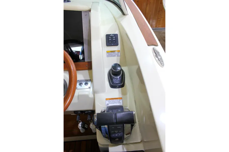 Slide: The Image of 2018 Chris-Craft Calypso 30 helm controls with joystick and steering wheel. - 41