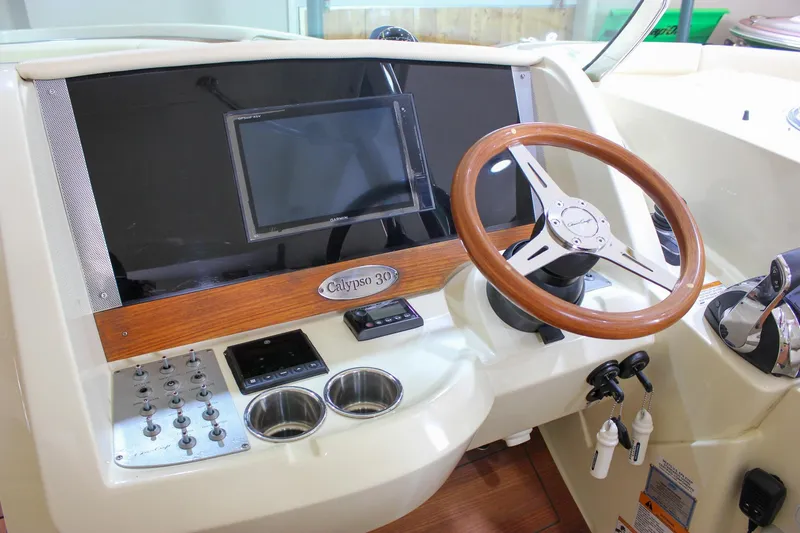 Slide: The Image of 2018 Chris-Craft Calypso 30 dashboard with steering wheel and control panel. - 43
