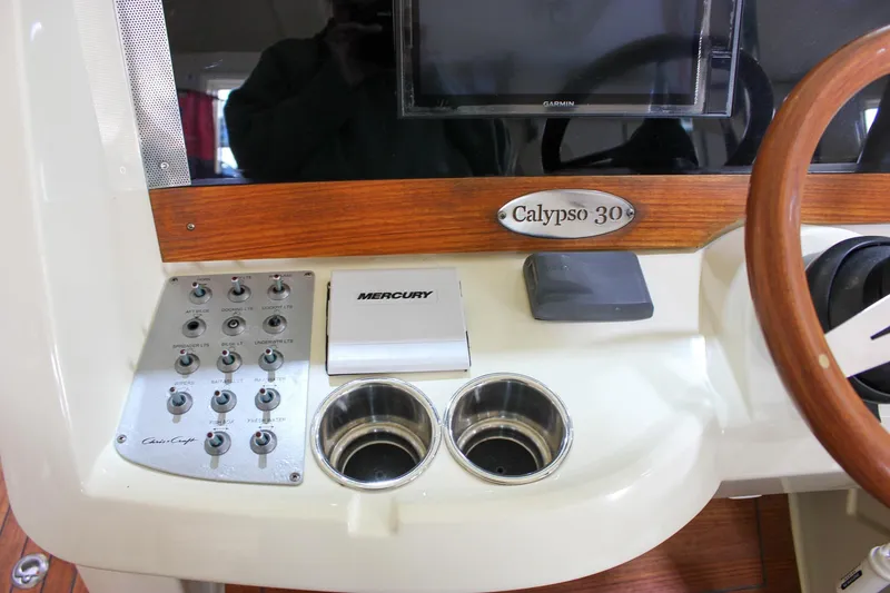 Slide: The Image of Control panel of 2018 Chris-Craft Calypso 30 boat with Mercury system and cup holders. - 48