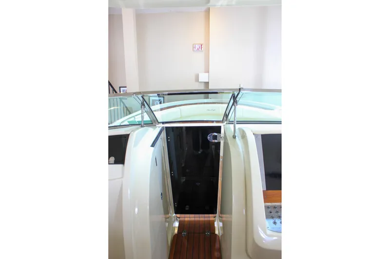 Slide: The Image of 2018 Chris-Craft Calypso 30 boat interior with glass door and wooden flooring. - 50