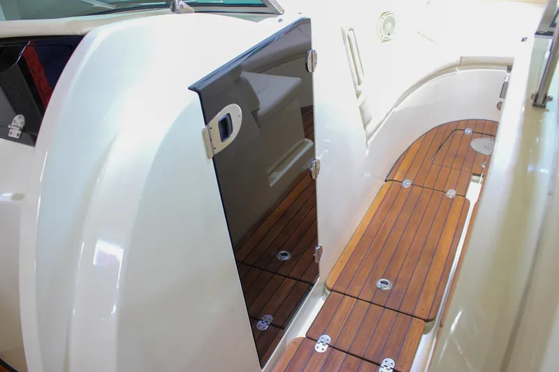 Slide: The Image of 2018 Chris-Craft Calypso 30 interior with teak flooring and sleek design. - 53
