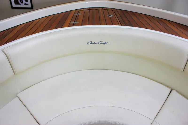 Slide: The Image of 2018 Chris-Craft Calypso 30 boat interior with white seating and wooden deck. - 55
