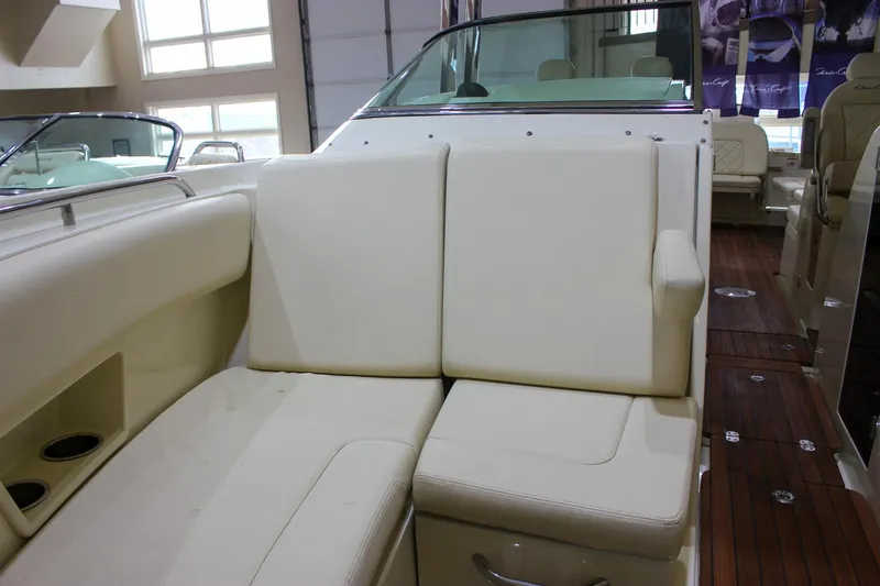Slide: The Image of 2018 Chris-Craft Calypso 30 interior with beige seating and wooden flooring. - 56
