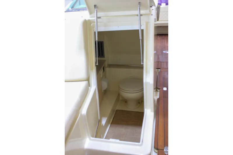 Slide: The Image of 2018 Chris-Craft Calypso 30 boat interior with compact marine toilet. - 58