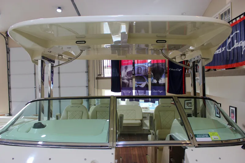 Slide: The Image of 2018 Chris-Craft Calypso 30 boat interior with seating and canopy in showroom. - 60