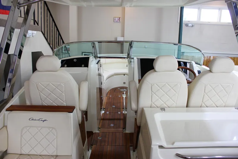 Slide: The Image of 2018 Chris-Craft Calypso 30 boat interior with luxurious seating and wooden accents. - 64