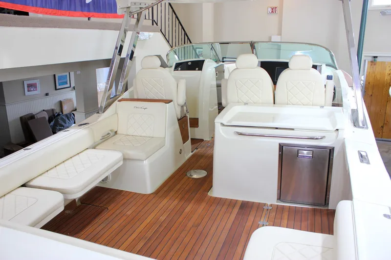 Slide: The Image of 2018 Chris-Craft Calypso 30 interior with luxurious seating and wooden flooring. - 65