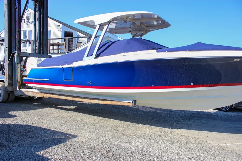 Slide: The Image of 2018 Chris-Craft Calypso 30 boat on display, front view, outdoors. - 7
