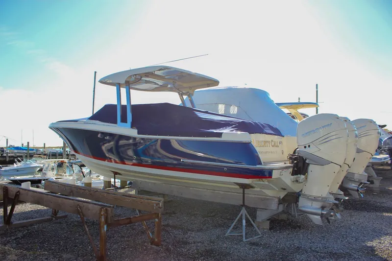 Slide: The Image of 2018 Chris-Craft Calypso 30 boat with twin Mercury outboards, docked and covered. - 74