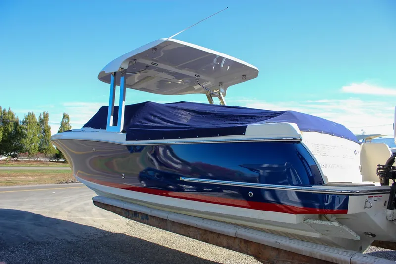 Slide: The Image of 2018 Chris-Craft Calypso 30 boat with blue cover, docked outdoors. - 77