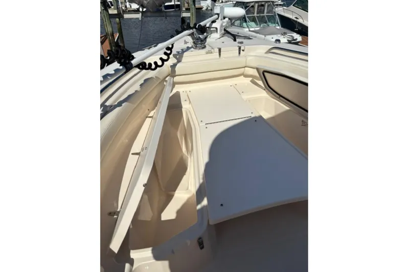 Slide: The Image of 2022 Grady-White Fisherman 257 boat interior with beige seating and cup holders. - 17
