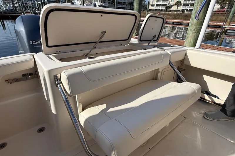 Slide: The Image of 2022 Grady-White Fisherman 257 boat interior with foldable seating and storage compartments. - 25