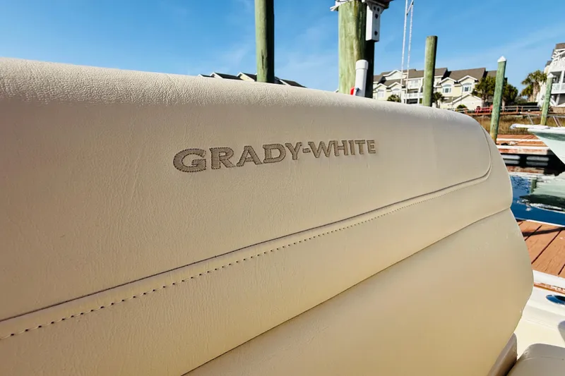 Slide: The Image of Grady-White Fisherman 257 boat seat, 2022 model, docked with clear sky background. - 33