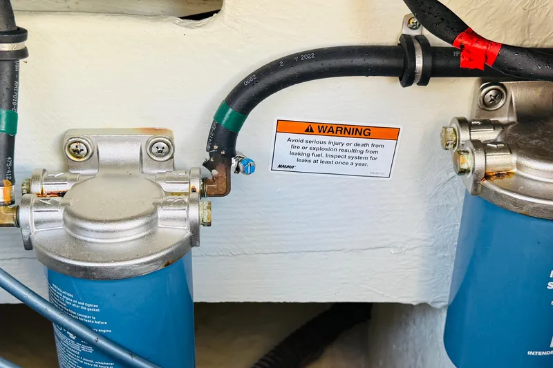 Slide: The Image of Close-up of 2022 Grady-White Fisherman 257 fuel system with warning label. - 35