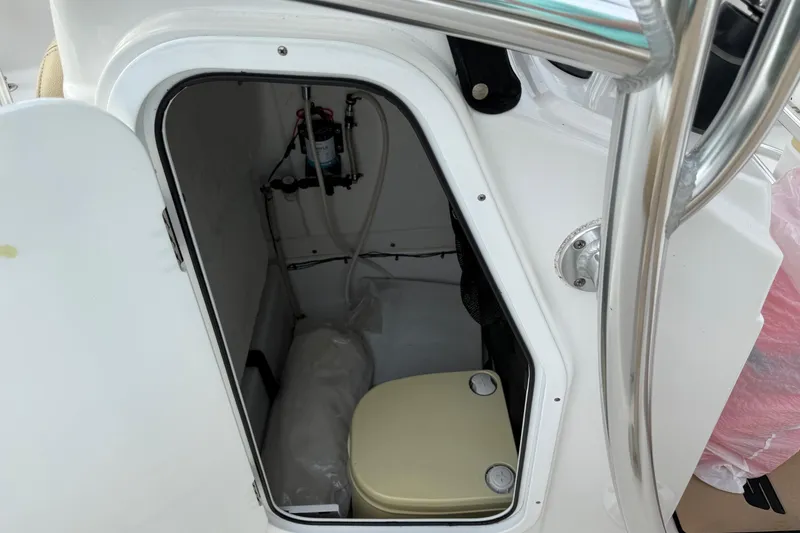 Slide: The Image of 2017 Sportsman Open 232 Center Console interior storage compartment with equipment. - 10