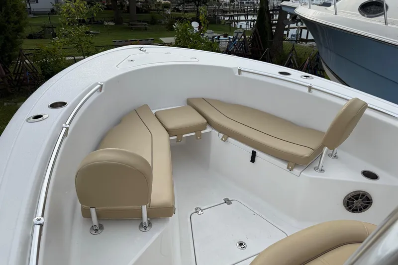 Slide: The Image of 2017 Sportsman Open 232 Center Console boat with beige seating and white deck. - 12