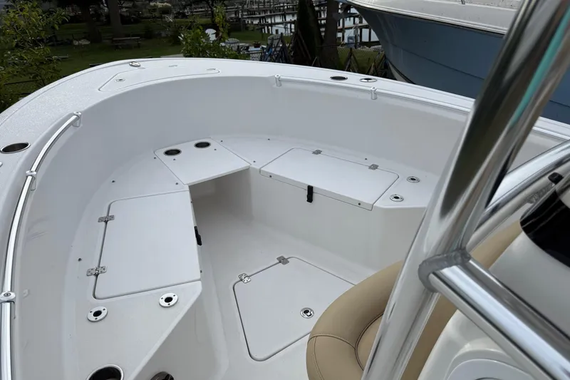 Slide: The Image of 2017 Sportsman Open 232 Center Console boat interior with storage compartments and seating. - 13