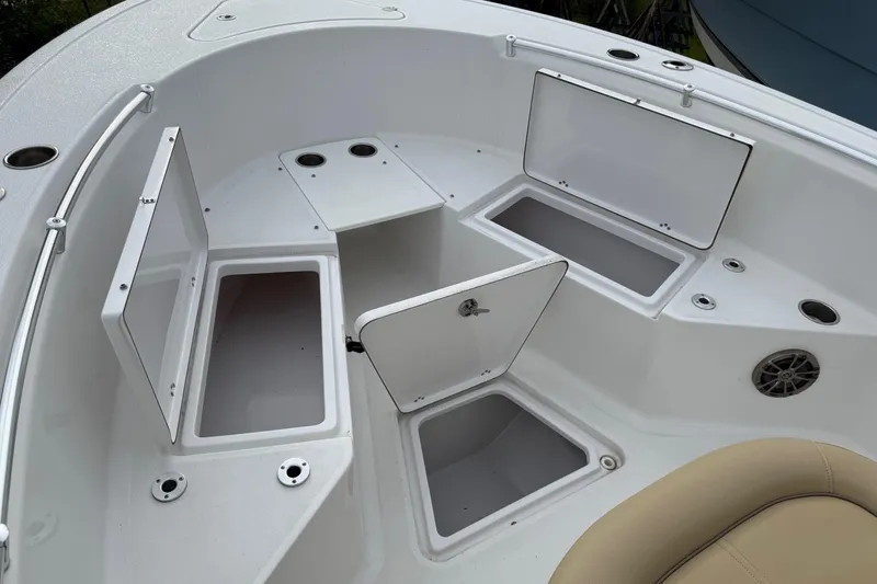 Slide: The Image of 2017 Sportsman Open 232 Center Console boat with open storage compartments. - 14