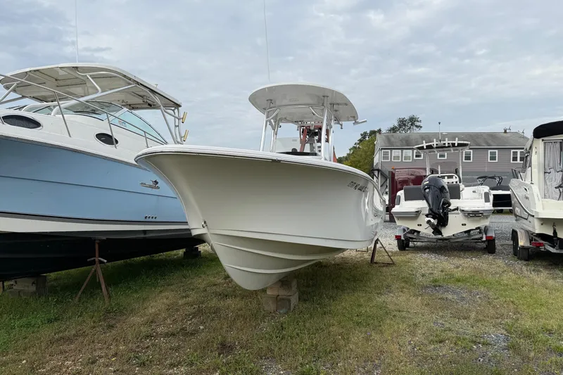 Slide: The Image of 2017 Sportsman Open 232 Center Console boat on display in a marina. - 3