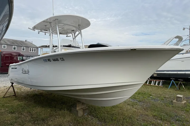 Slide: The Image of 2017 Sportsman Open 232 Center Console boat on display outdoors. - 4