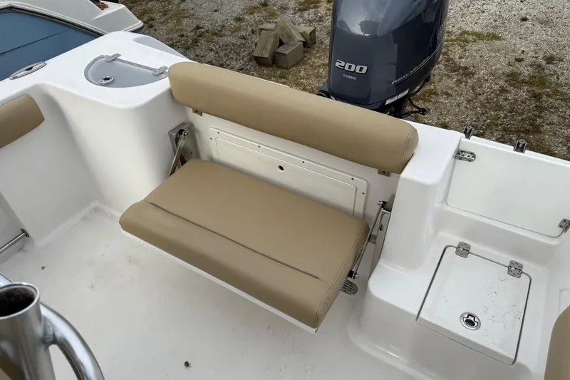 Slide: The Image of 2017 Sportsman Open 232 Center Console boat interior with tan seating and Yamaha 200 engine. - 7