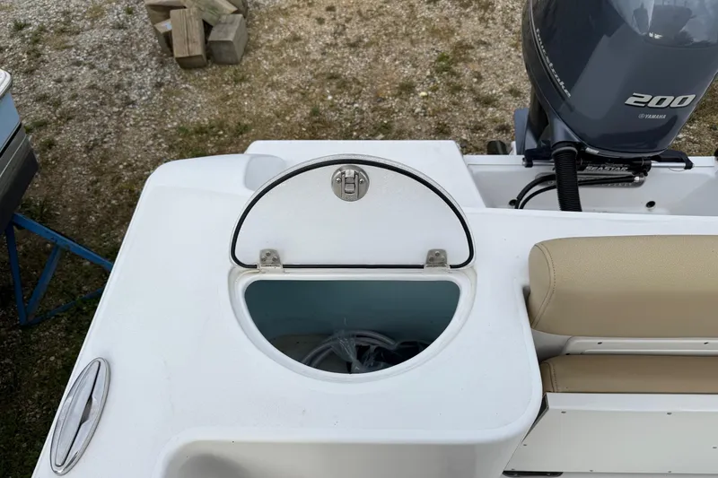 Slide: The Image of 2017 Sportsman Open 232 Center Console boat with Yamaha 200 engine, open storage compartment. - 8