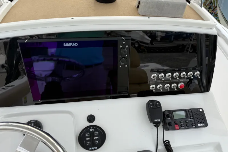 Slide: The Image of 2017 Sportsman Open 232 Center Console dashboard with Simrad electronics and control switches. - 9