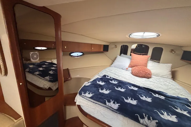 Slide: The Image of Luxurious 2002 Cruisers Yachts cabin interior with cozy bed and elegant decor. - 13