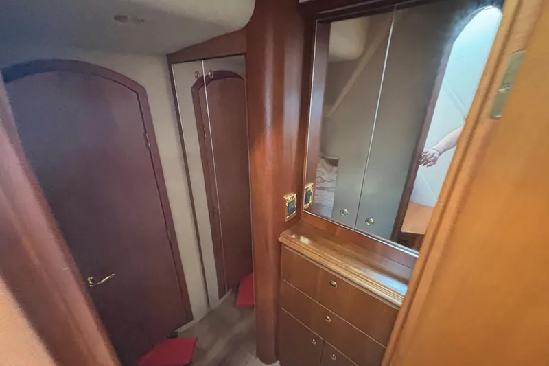 Slide: The Image of Interior of 2002 Cruisers Yachts with wooden cabinetry and mirrored closet. - 17