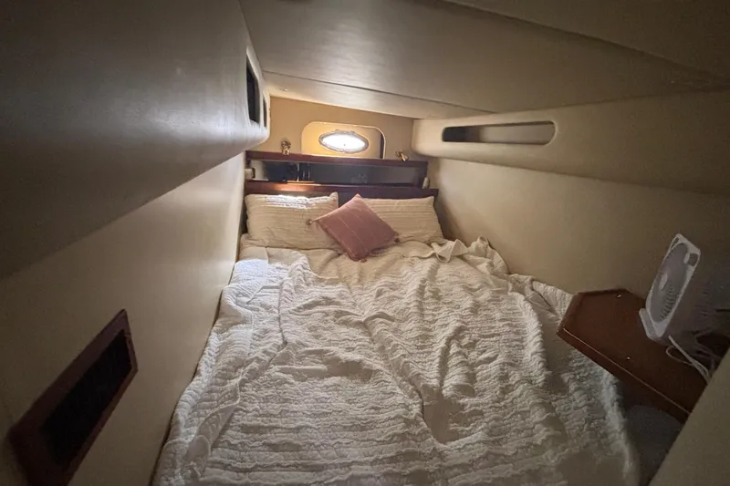 Slide: The Image of Cozy cabin bedroom in a 2002 Cruisers Yachts, featuring a comfortable bed and soft lighting. - 18