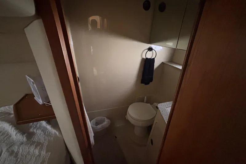 Slide: The Image of 2002 Cruisers Yachts bathroom interior with toilet, towel, and sink. - 19