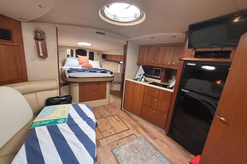 Slide: The Image of Interior of 2002 Cruisers Yachts with cozy cabin, kitchenette, and bed. - 21